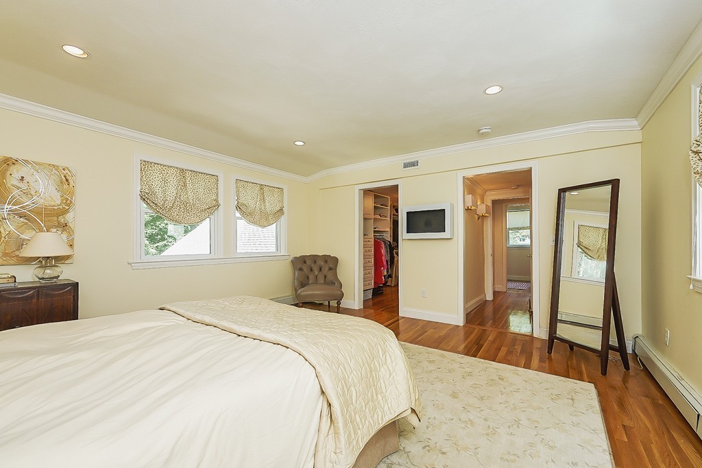 236 Hayward Mill Road Concord, MA 01742 - Photo 13 of 26 a bedroom with a large bed a painting and a lamp