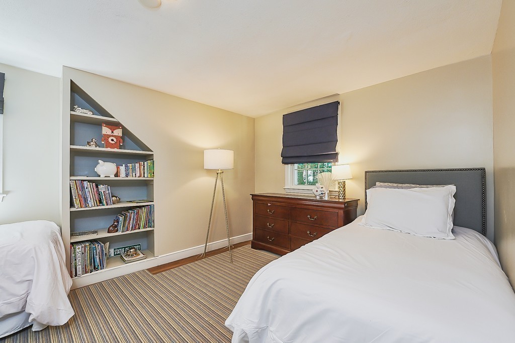 236 Hayward Mill Road Concord, MA 01742 - Photo 16 of 26 a bedroom with a bed and a book shelf