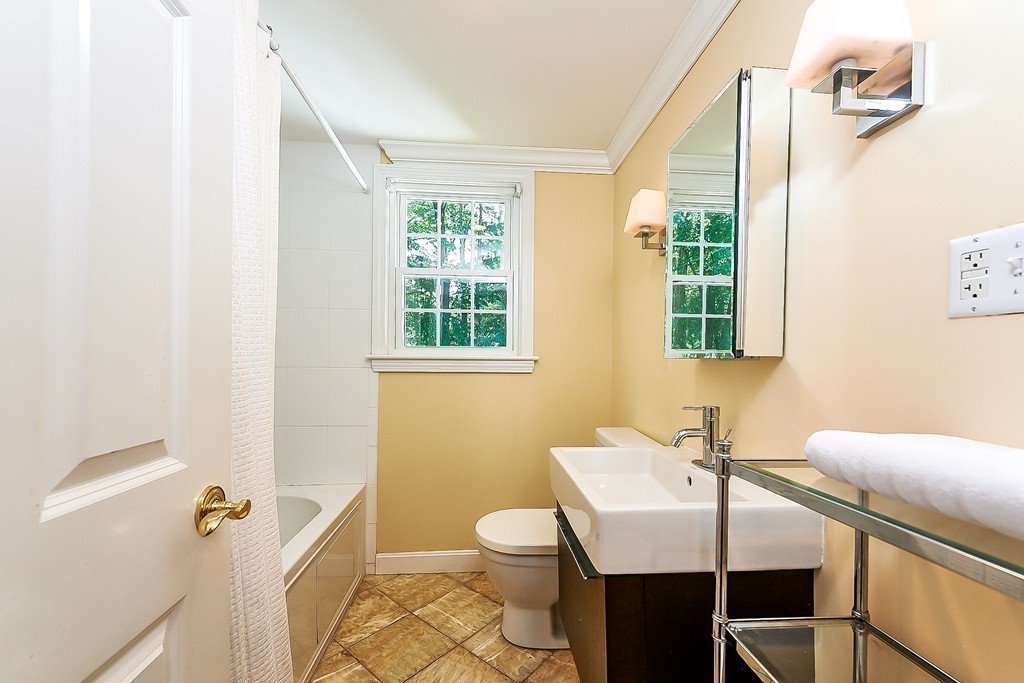236 Hayward Mill Road Concord, MA 01742 - Photo 17 of 26 a bathroom with a sink a toilet and a window
