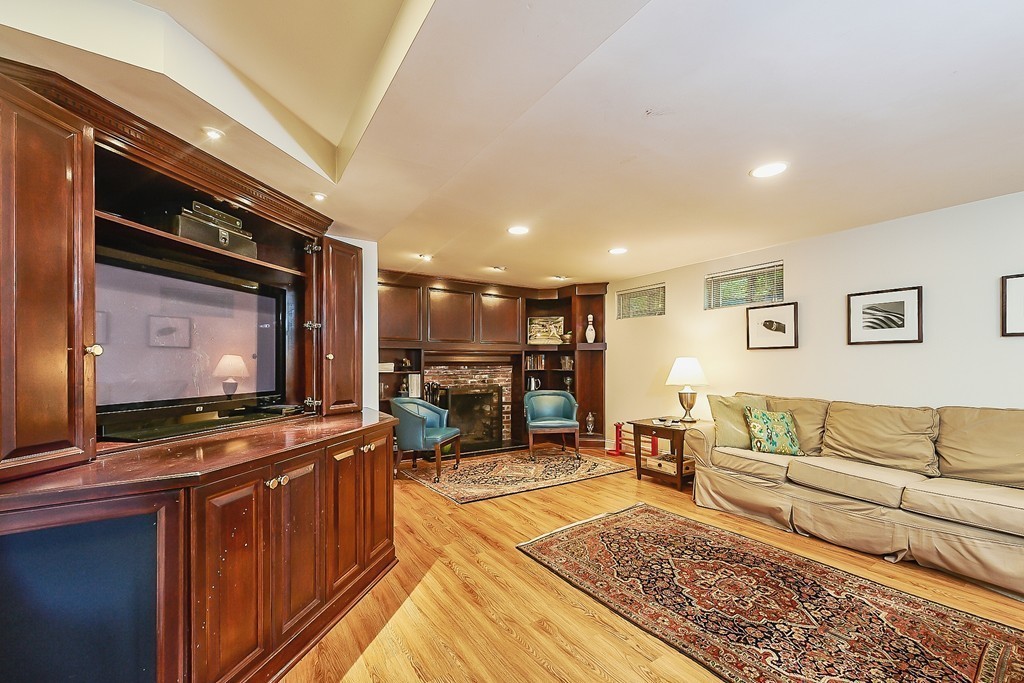 236 Hayward Mill Road Concord, MA 01742 - Photo 19 of 26 a living room with furniture and a flat screen tv