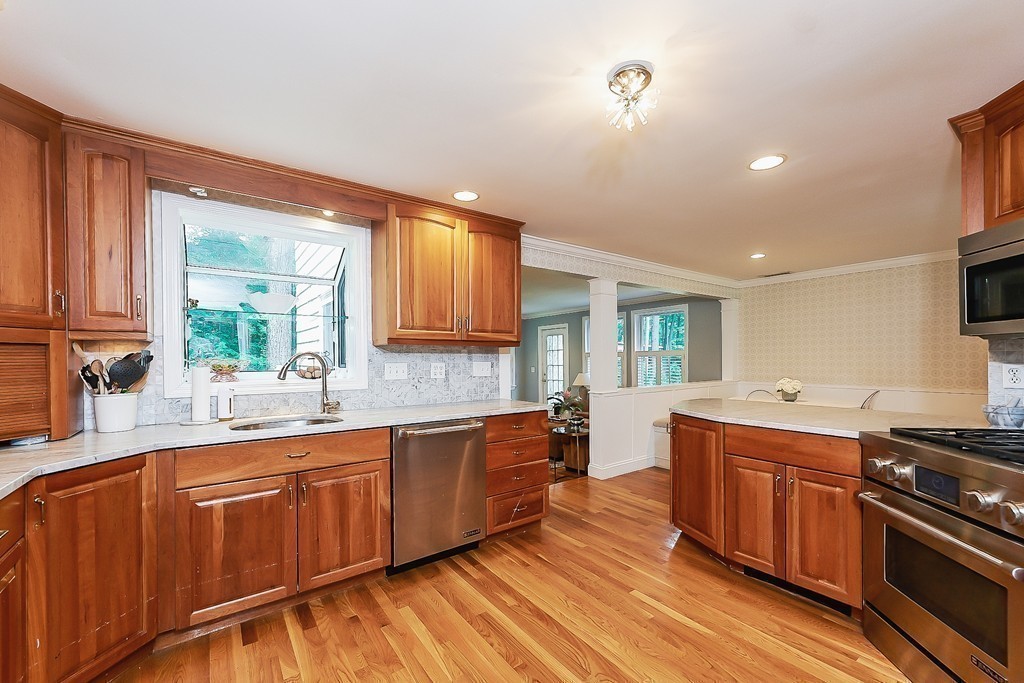 236 Hayward Mill Road Concord, MA 01742 - Photo 8 of 26 a kitchen with a sink wooden floor and stainless steel appliances