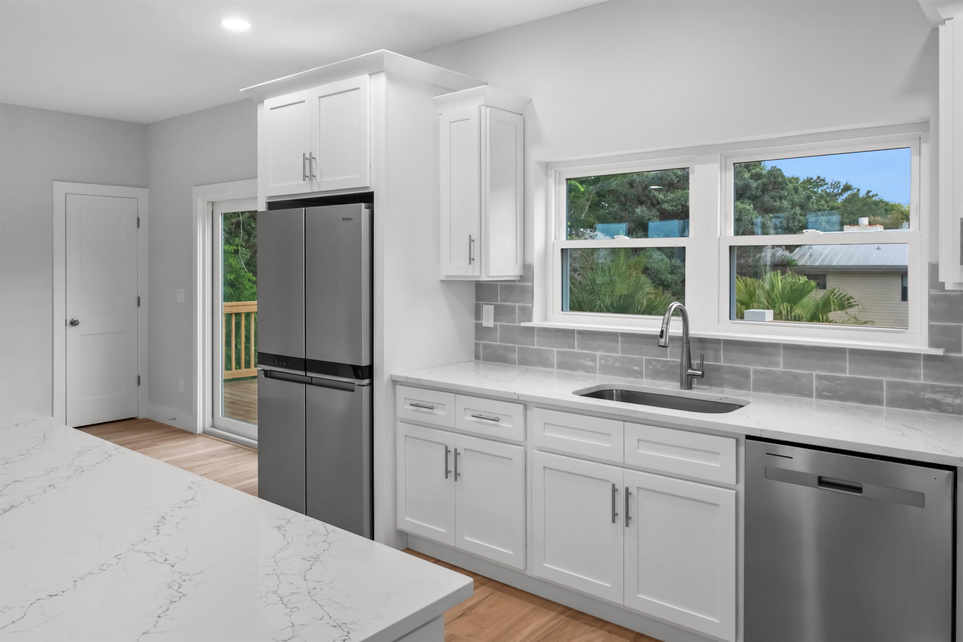 137 Ferrol Road St. Augustine, FL 32084 - Photo 25 of 55 a kitchen with white cabinets and a window