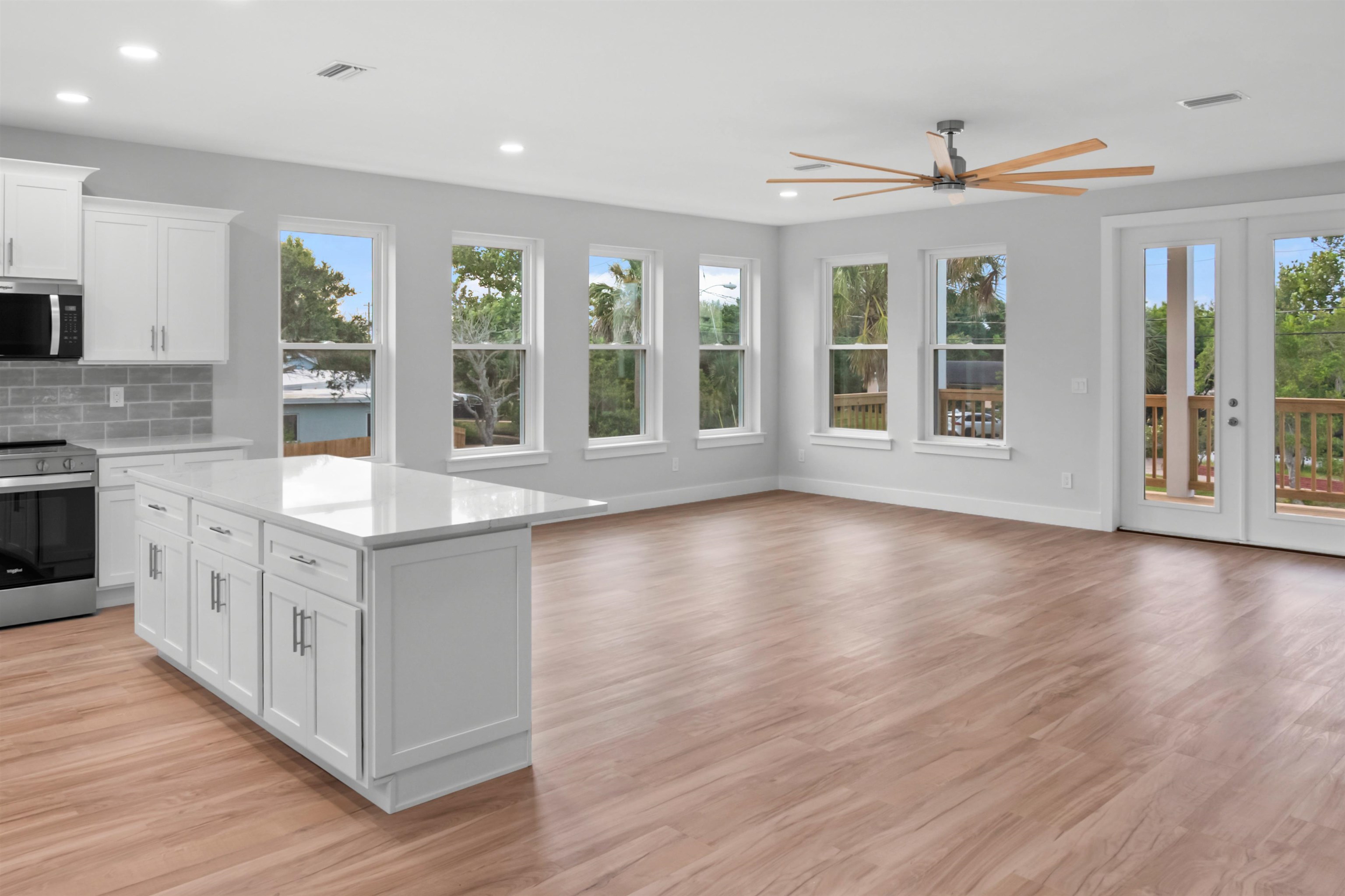 137 Ferrol Road St. Augustine, FL 32084 - Photo 26 of 55 a large kitchen with stainless steel appliances granite countertop a white stove top oven and a dishwasher next to a large window