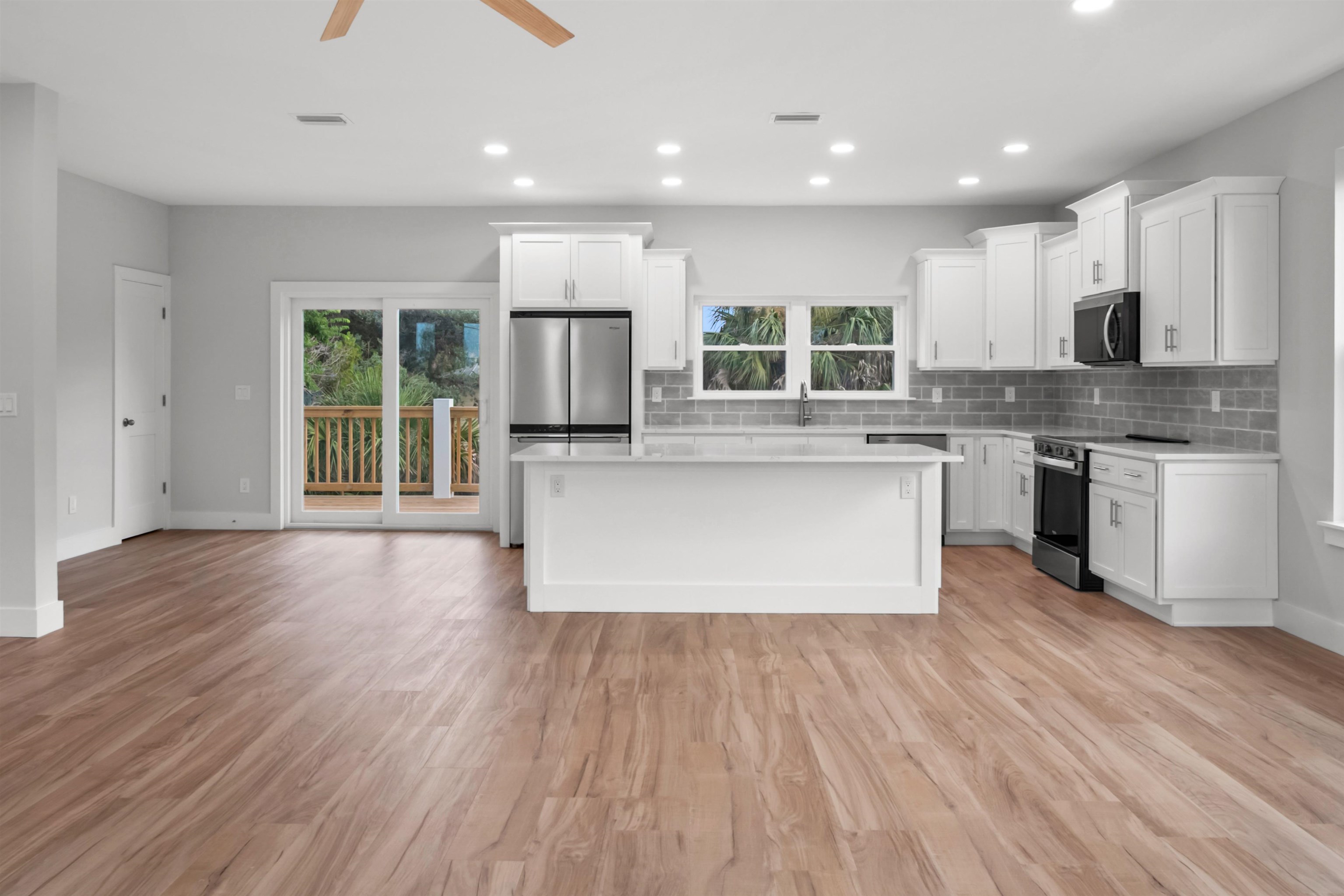 137 Ferrol Road St. Augustine, FL 32084 - Photo 31 of 55 a large kitchen with wooden floors and stainless steel appliances
