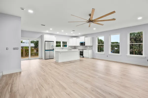 a large kitchen with stainless steel appliances granite countertop a large counter top and a stove