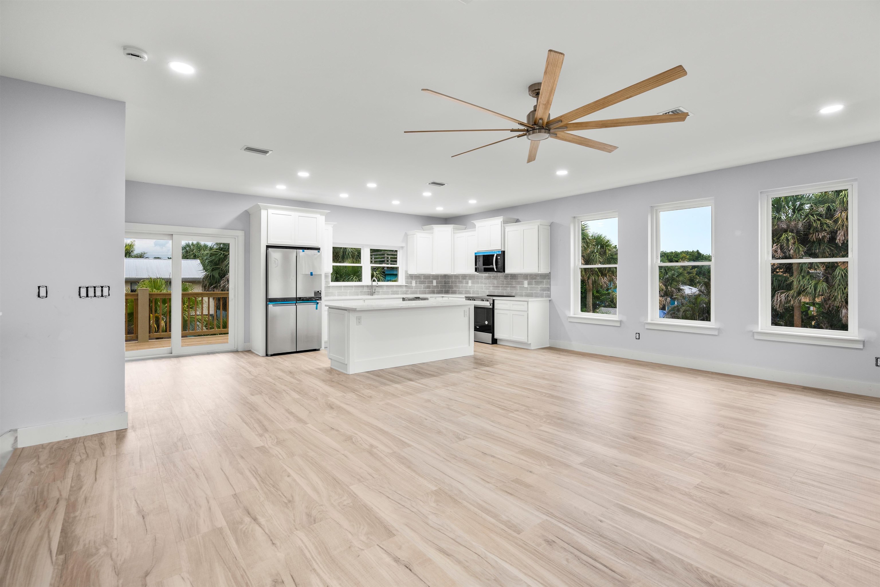 137 Ferrol Road St. Augustine, FL 32084 - Photo 4 of 55 a view of an empty room with a window and wooden floor