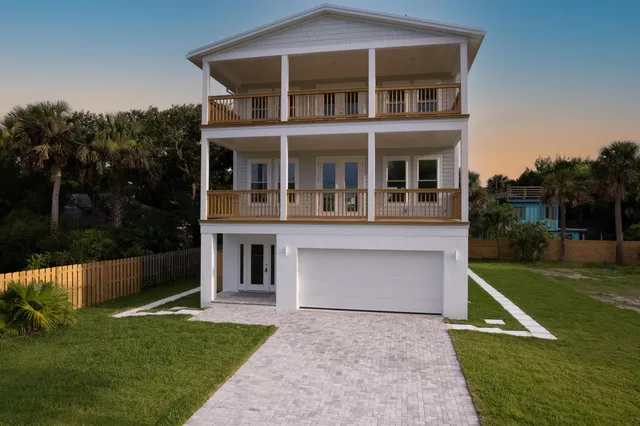 an aerial view of a house with a yard basket ball court and outdoor seating