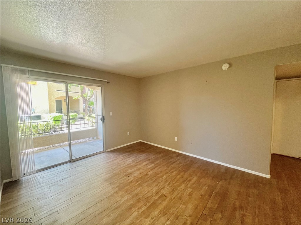 7885 West Flamingo Road, Unit 1029 Las Vegas, NV 89147 - Photo 2 of 18 Floor-to-ceiling sliding glass doors open to a private outdoor space.