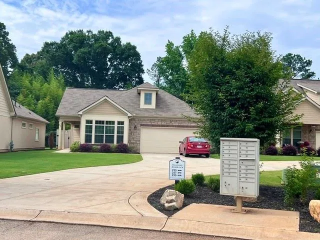 a front view of a house with a yard and outdoor seating