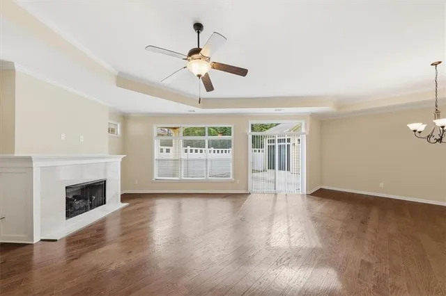 a view of empty room with fireplace and wooden floor