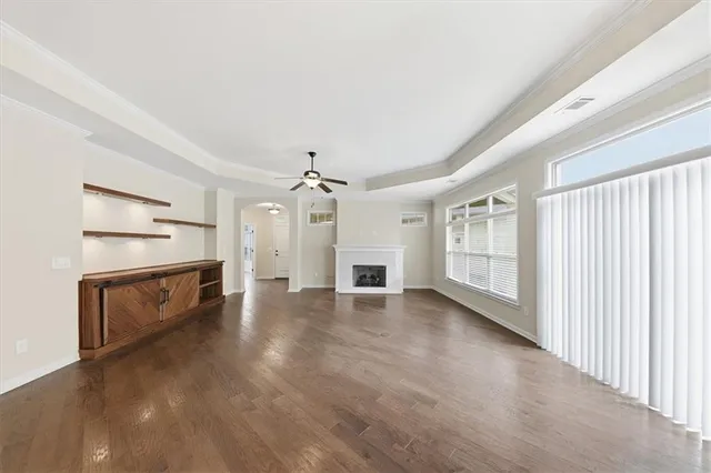 a kitchen with kitchen island stainless steel appliances a stove and wooden floor