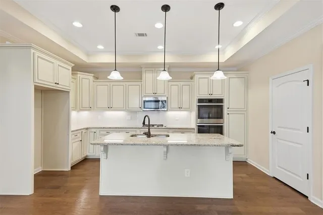 a kitchen with a refrigerator a sink and cabinets