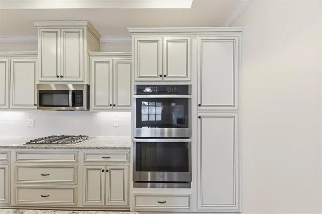 a kitchen with stainless steel appliances granite countertop a sink a stove and a wooden floors