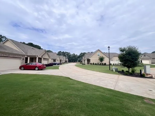 a view of a house with a yard and sitting area