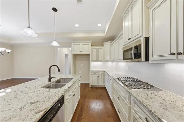 an empty room with chandelier fan
