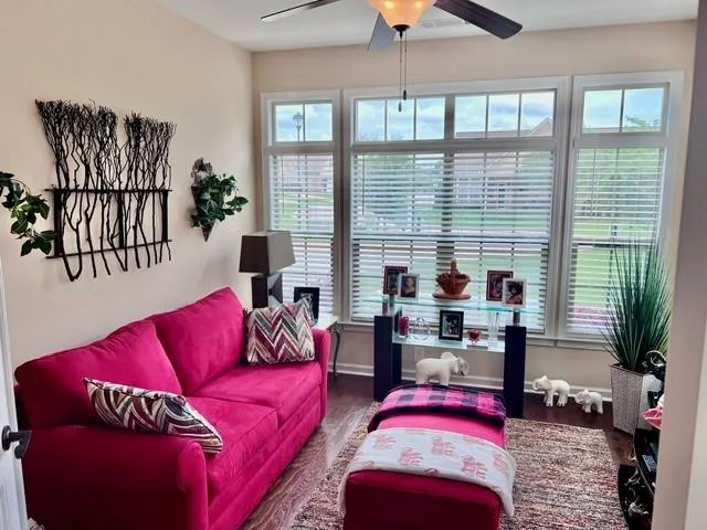 a living room with furniture and a large window
