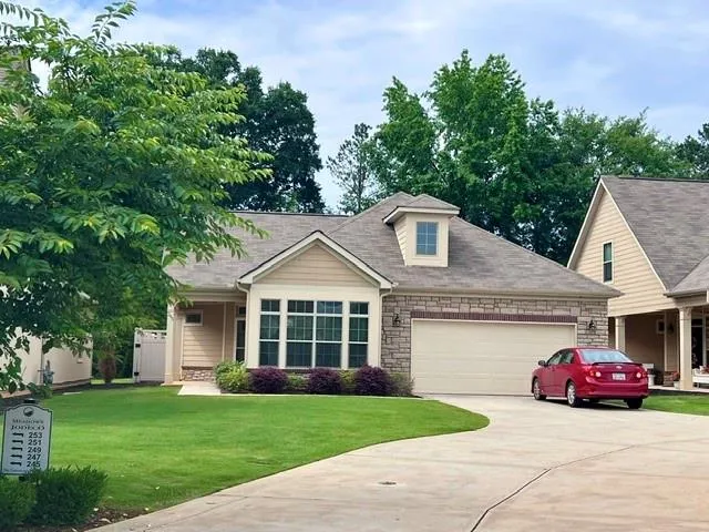 a view of a house with a yard and garage