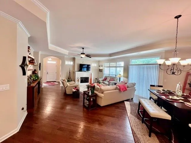 a living room with fireplace furniture and a wooden floor