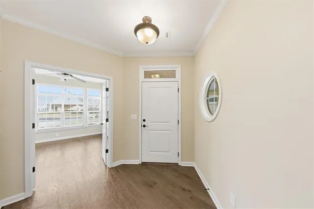 a view of a room with wooden floor and white walls