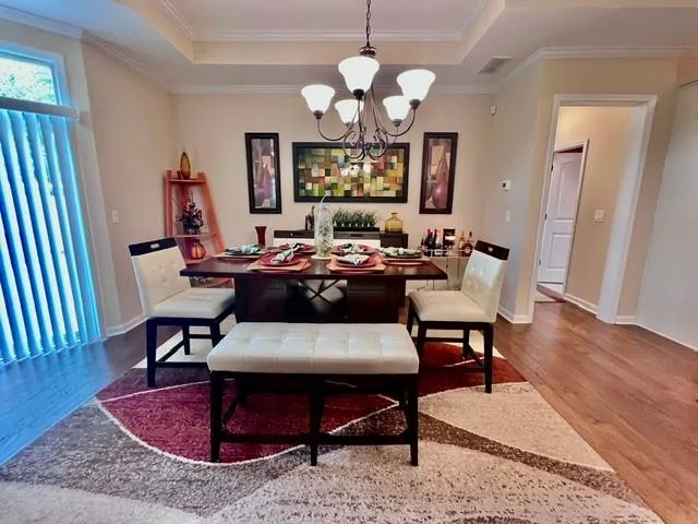a living room with furniture a table and wooden floor