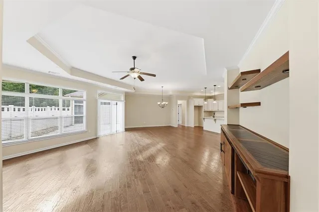 a view of empty room with wooden floor and window