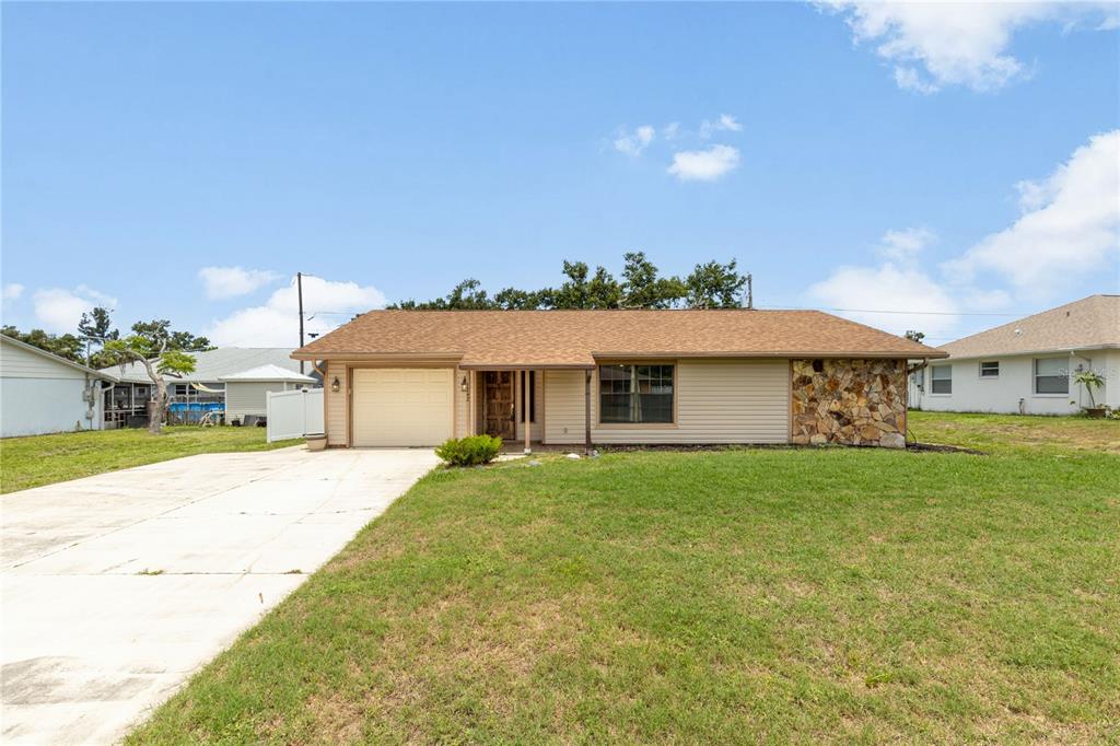 3242 Nocturne Road Venice, FL 34293 - Photo 1 of 1 a front view of a house with a yard and garage
