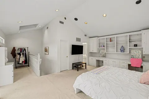 a living room with furniture a fireplace and a floor to ceiling window