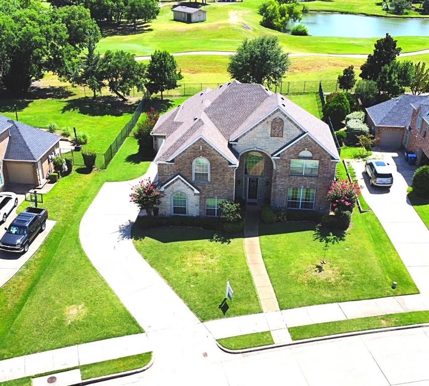 View from above of property featuring a large body of water and a local golf course