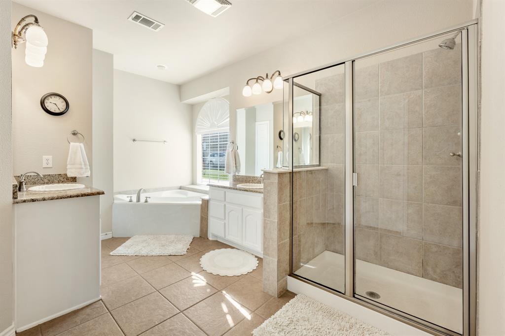 10601 Huffines Drive Rowlett, TX 75089 - Photo 16 of 29 a bathroom with a shower sink and mirror
