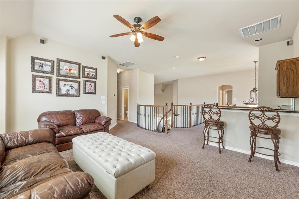 10601 Huffines Drive Rowlett, TX 75089 - Photo 19 of 29 a living room with furniture and a flat screen tv
