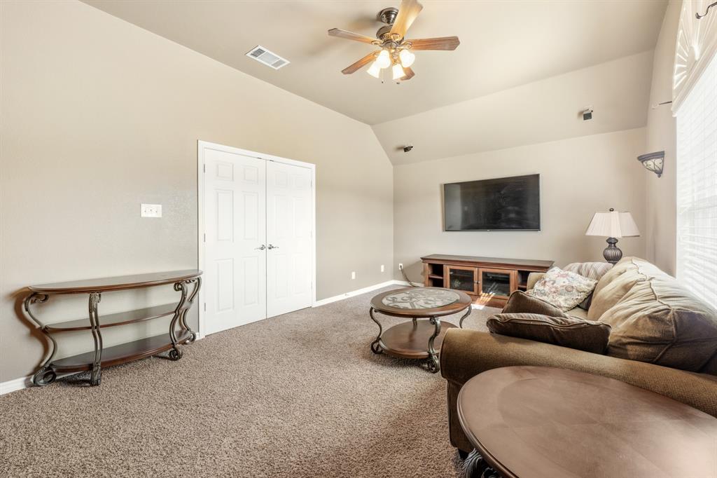 10601 Huffines Drive Rowlett, TX 75089 - Photo 21 of 29 a living room with furniture and a flat screen tv