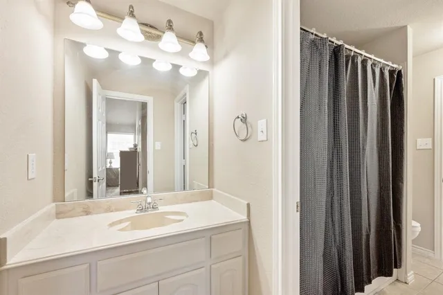 a bathroom with a sink vanity and mirror