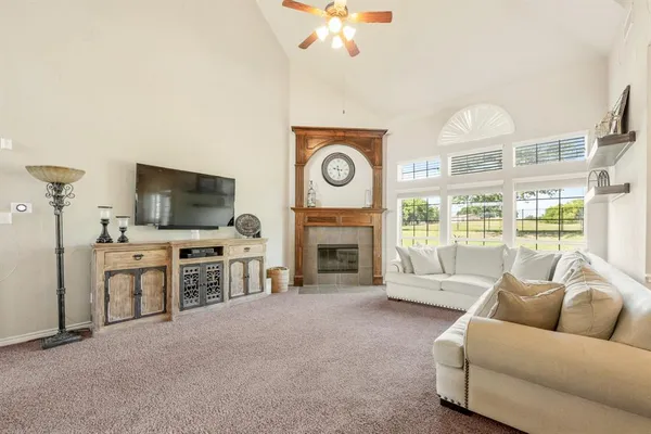 a living room with furniture fireplace and flat screen tv