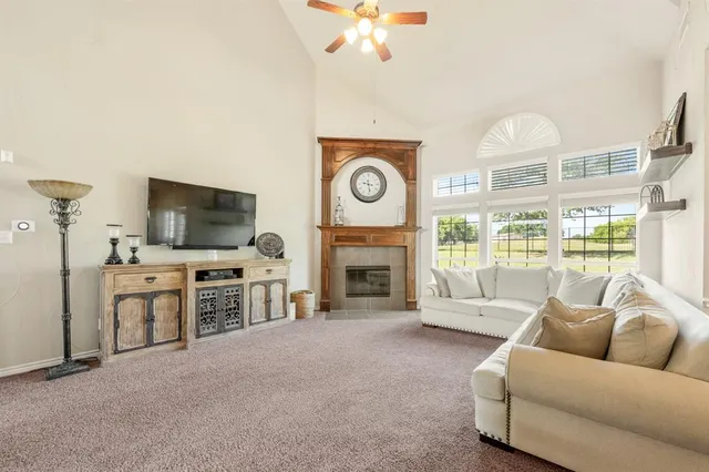 a living room with furniture fireplace and flat screen tv