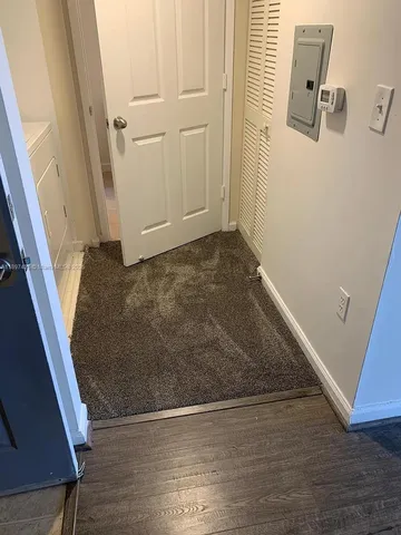 an empty room with wooden floor and white walls