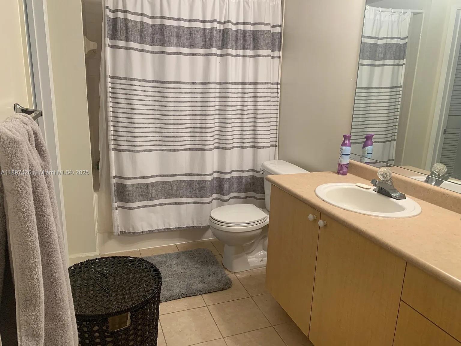 1919 Van Buren Street, Unit 719A Hollywood, FL 33020 - Photo 9 of 17 a bathroom with a sink a toilet and tub