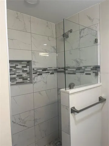 a bathroom with a shower and mirror