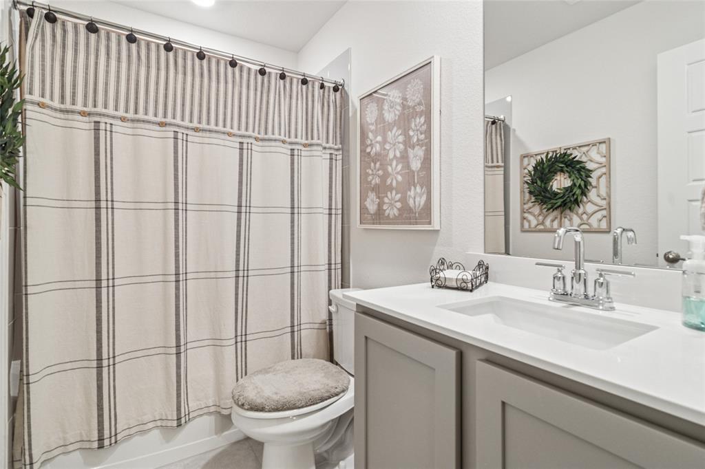 113 Lantern Road Caddo Mills, TX 75135 - Photo 10 of 25 a bathroom with a sink a toilet and a mirror