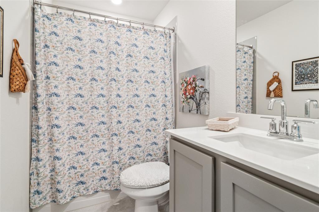 113 Lantern Road Caddo Mills, TX 75135 - Photo 12 of 25 a bathroom with a sink toilet and a mirror