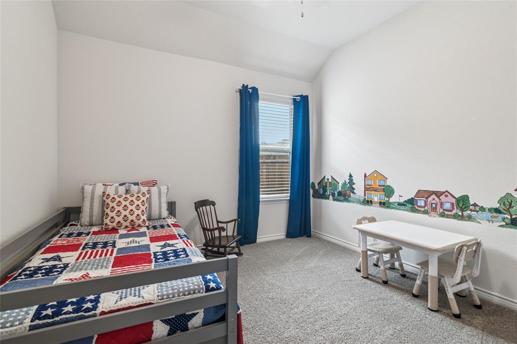 113 Lantern Road Caddo Mills, TX 75135 - Photo 15 of 25 a bedroom with furniture and a book shelf