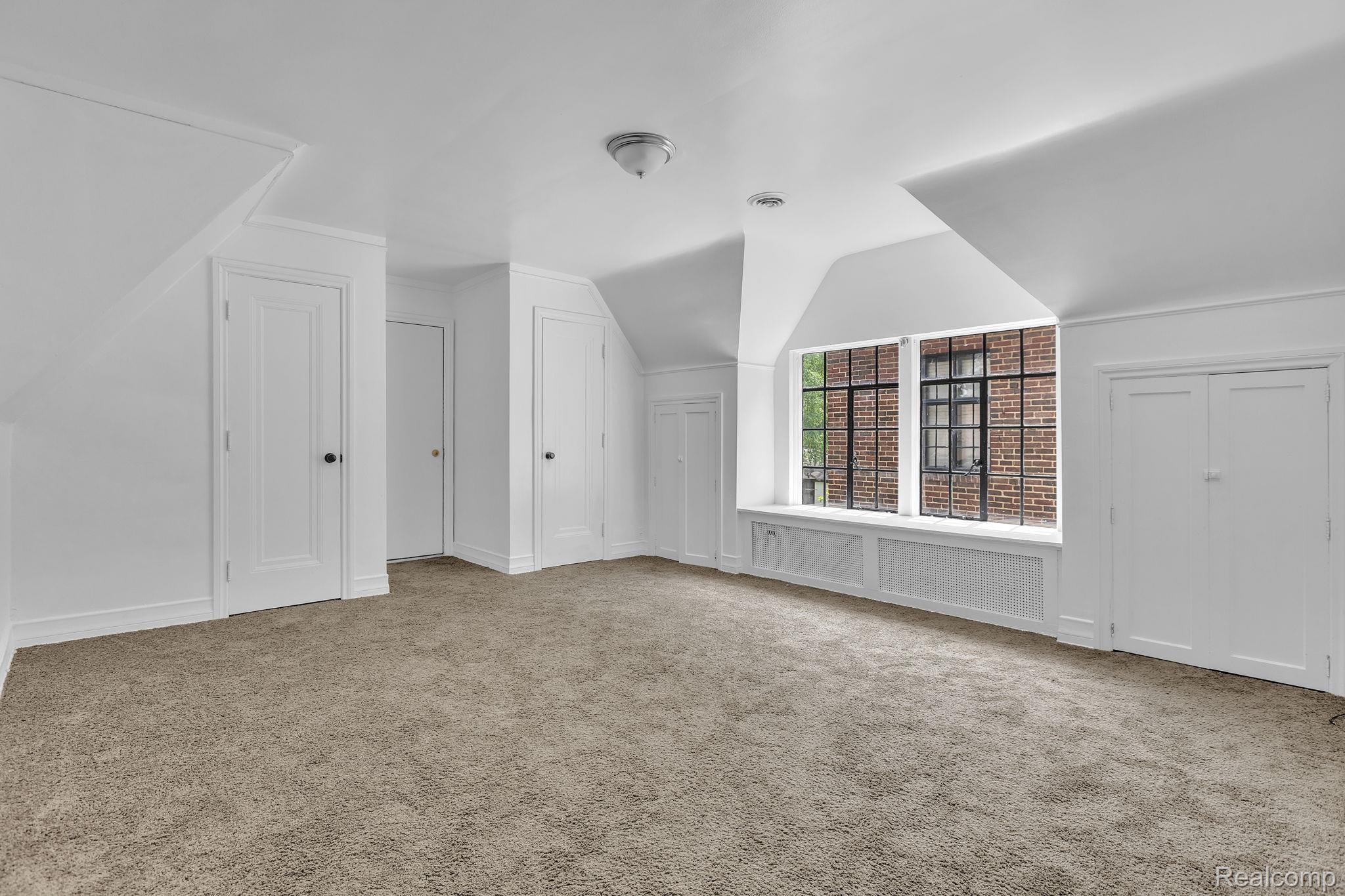 19510 Stratford Road Detroit, MI 48221 - Photo 32 of 45 Attic room featuring neutral carpeting, white walls, and sloped ceilings