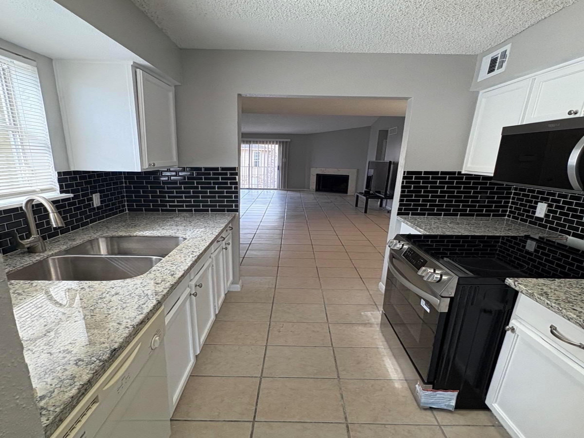 10101 South Gessner Road, Unit 515 Houston, TX 77071 - Photo 7 of 10 a kitchen with a sink stove and cabinets
