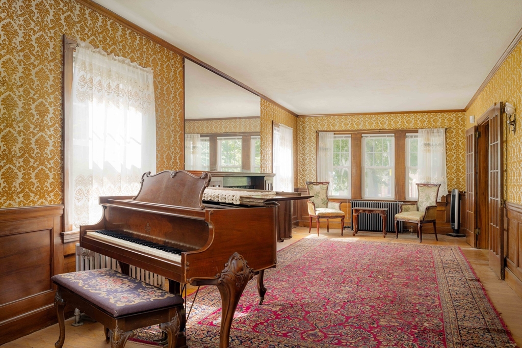 45 Pershing Road Boston, MA 02130 - Photo 11 of 29 a living room with furniture a wooden floor and a piano