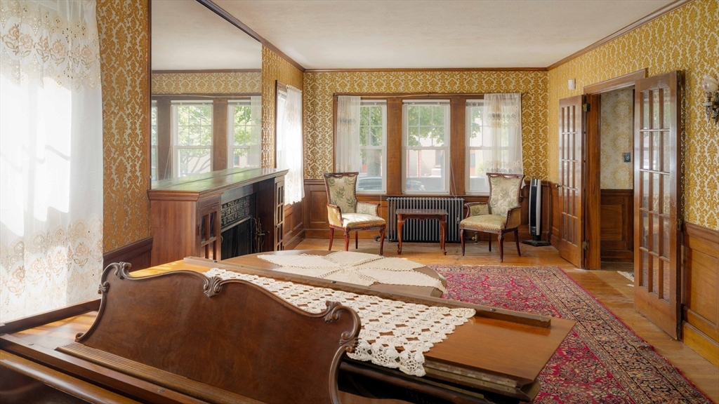 45 Pershing Road Boston, MA 02130 - Photo 12 of 29 a living room with furniture fireplace and a table