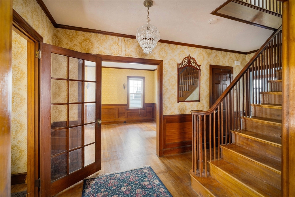 45 Pershing Road Boston, MA 02130 - Photo 2 of 29 a view of entryway and hall with wooden floor and a front door