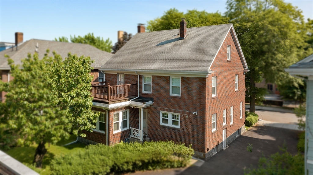 45 Pershing Road Boston, MA 02130 - Photo 21 of 29 a aerial view of a house with a yard and potted plants