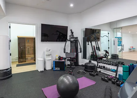 a dining room with furniture a chandelier and wooden floor