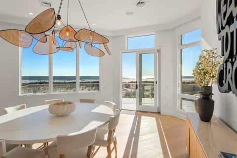 a bedroom with a large bed and a large window with the outer view
