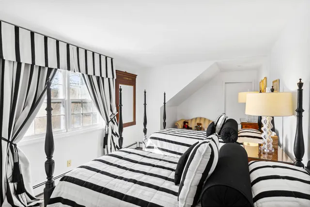 a bedroom with bed and a window