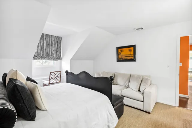 a bedroom with a bed and couch